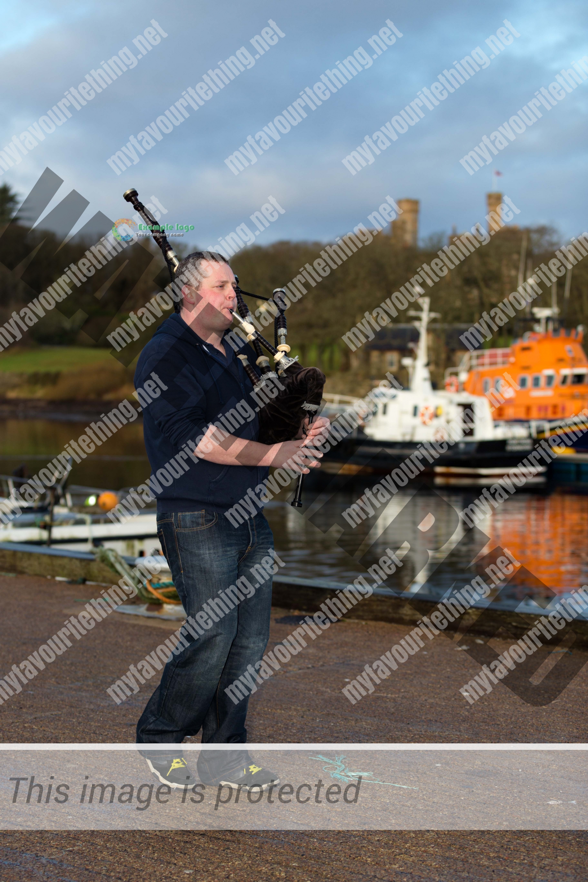 Ross Macrae playing his bagpipes at Stornoway Harbour, Isle of Lewis
