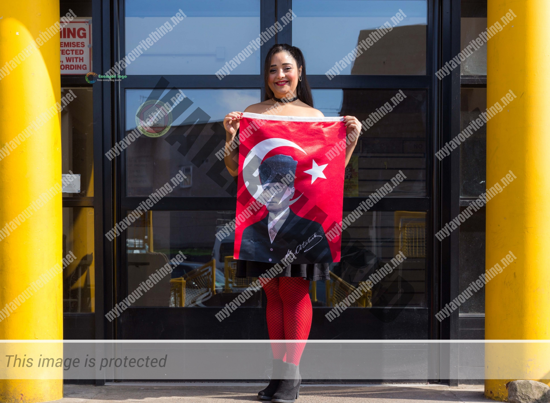 Flautist Koza Unal with the flag of Turkey featuring Ataturk, outside the Malcolm X Centre in Bristol